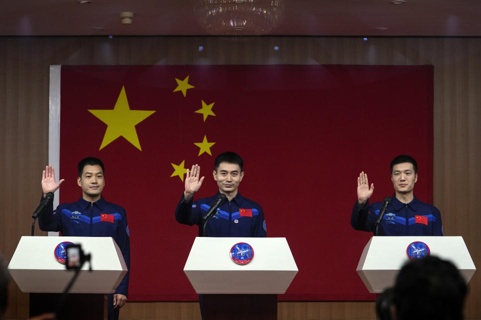 Chinese astronauts for the upcoming Shenzhou-18 mission, from left, Li Guangsu, Ye Guangfu and Li Cong wave as they arrive for a meeting with the press at the Jiuquan Satellite Launch Center in northwest China, Wednesday, April 24, 2024. (AP Photo/Andy Wong)