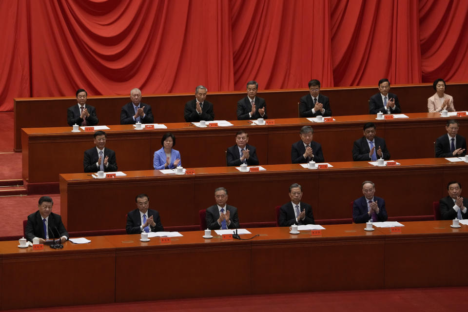 Delegates applaud as Chinese President Xi Jinping, left, delivers a speech at an event commemorating the 110th anniversary of Xinhai Revolution at the Great Hall of the People in Beijing, Saturday, Oct. 9, 2021. (AP Photo/Andy Wong)