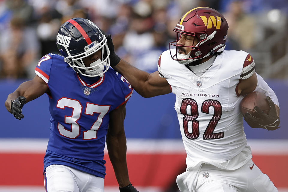 Washington Commanders tight end Logan Thomas (82) pushes off New York Giants cornerback Tre Hawkins III (37) during the third quarter of an NFL football game, Sunday, Oct. 22, 2023, in East Rutherford, N.J. (AP Photo/Adam Hunger)