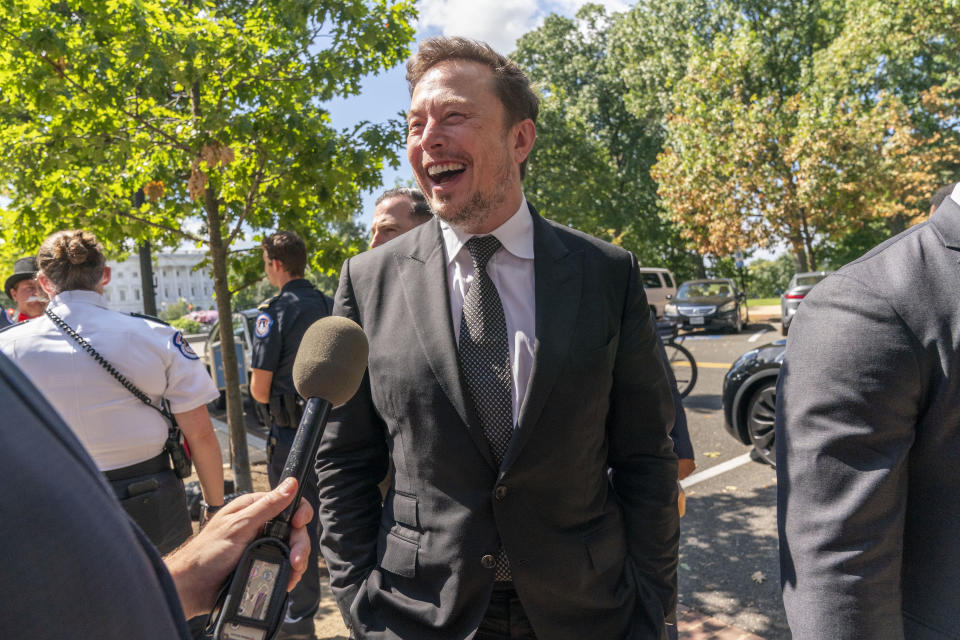 Elon Musk laughs while speaking to reporters after attending a closed-door meeting with lawmakers and fellow tech CEOs on artificial intelligence in Washington, D.C., on Wednesday. (Jacquelyn Martin/AP)