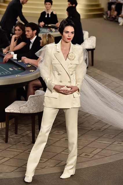 Well this is certainly a new look for Kendall Jenner! The 19-year-old supermodel walked the Chanel runway on Tuesday, trading in her long dark locks for a severe, stick-straight bob. Proving she can pull off just about any look, Kendall was a standout in an edgy off-white pantsuit complete with a long train. <strong>WATCH: Kendall Jenner Flashes Her Butt Cheeks In Shortest Shorts Imagineable</strong> Getty Images Getty Images Getty Images Cementing her status in the high-fashion world, Kendall was the chosen model to strike a pose with legendary Chanel designer Karl Lagerfeld at the end of the show, which she of course happily Instagrammed about. "Of course I said yes. #Chanel #HauteCouture," she wrote. Check out Kendall and Karl looking like a bride and groom. The reality star's already made an impressive mark on Paris Fashion Week, walking the Versace runway on Sunday. Getty Images <strong>WATCH: Kendall Jenner and a Shirtless Justin Bieber Star in Sexy 'Vogue' Shoot</strong> In March, Kendall memorably graced the Chanel runway, but with her bestie, supermodel Cara Delevingne. Watch below: