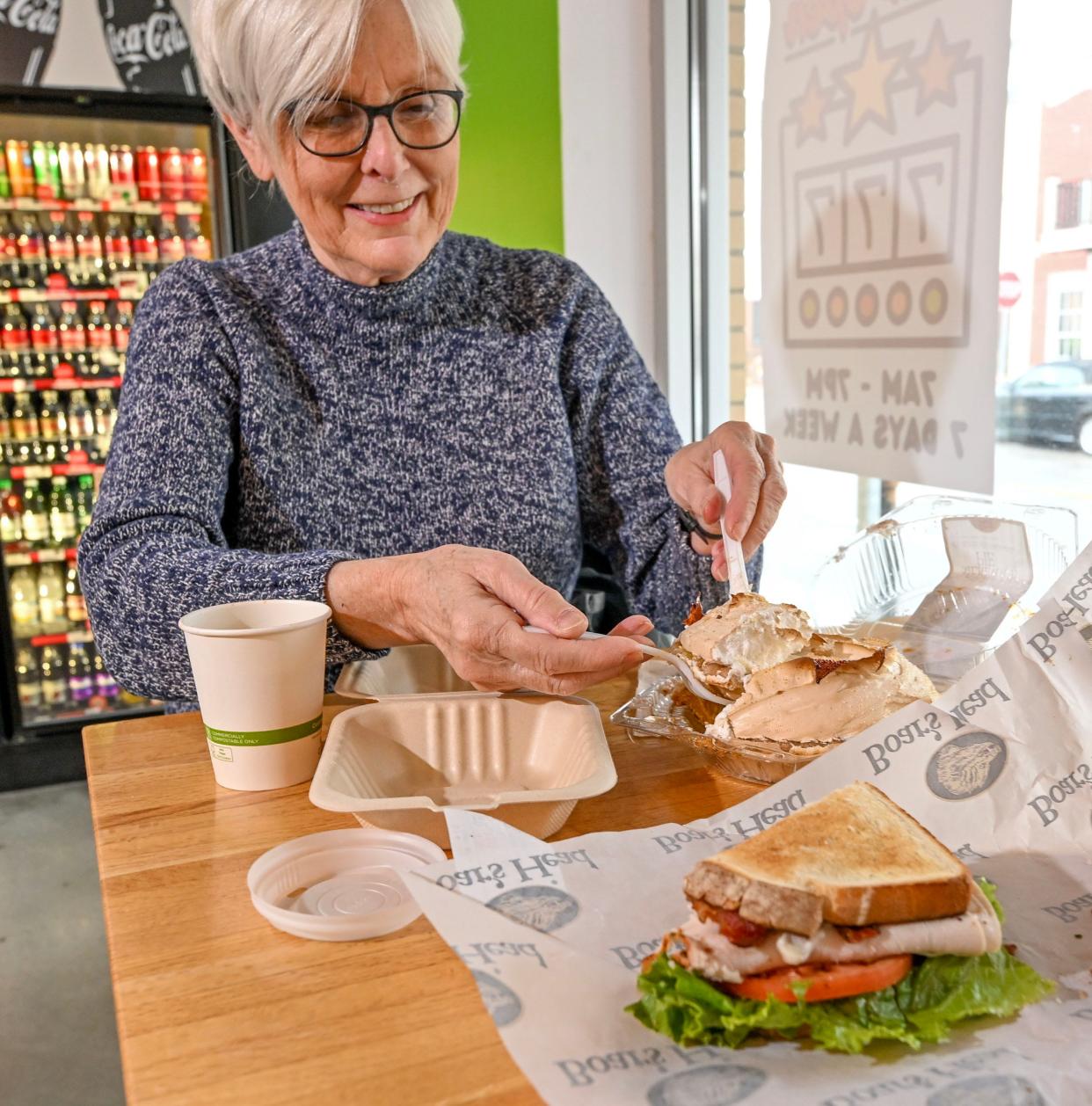 Susan Shelton of Falmouth dishes up a slice of a small lemon meringue pie from Montilio's Bakery, sold at Mashpee Fresh Market