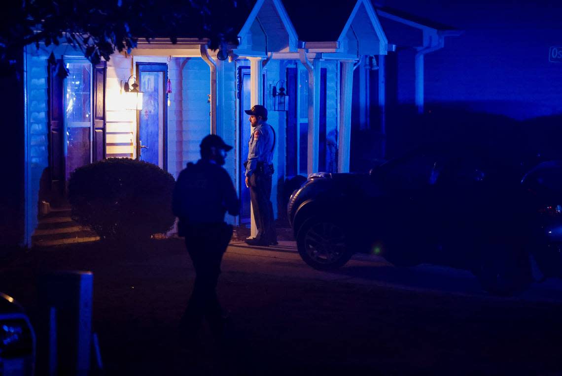 Raleigh Police officers walk door to door checking on residents in the Hedingham neighborhood and Neuse River Trail area in Raleigh after 5 people were shot and killed Thursday, Oct. 13, 2022.