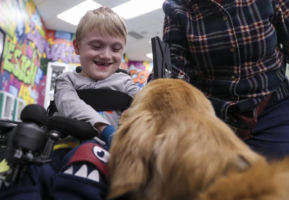First-grader Nolan Ferguson pets Astro, the Howard-Suamico School District therapy dog, on Tuesday, January 23, 2024, at Bay Harbor Elementary School in Suamico, Wis. 
Tork Mason/USA TODAY NETWORK-Wisconsin