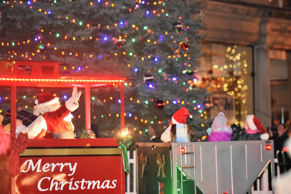 Santa Claus waves after lighting the Christmas tree in Chambersburg's Memorial Square during the Christmas Parade in 2021.