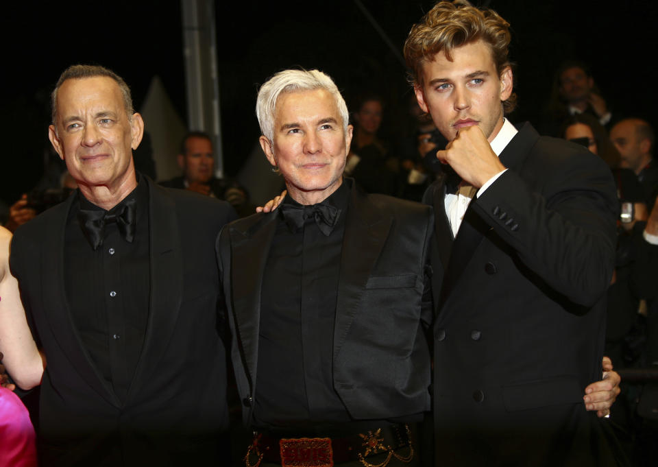 Tom Hanks, Baz Luhrmann, and Austin Butler pose for photographers after the premiere of “Elvis” at Cannes - Credit: Joel C Ryan/Invision/AP
