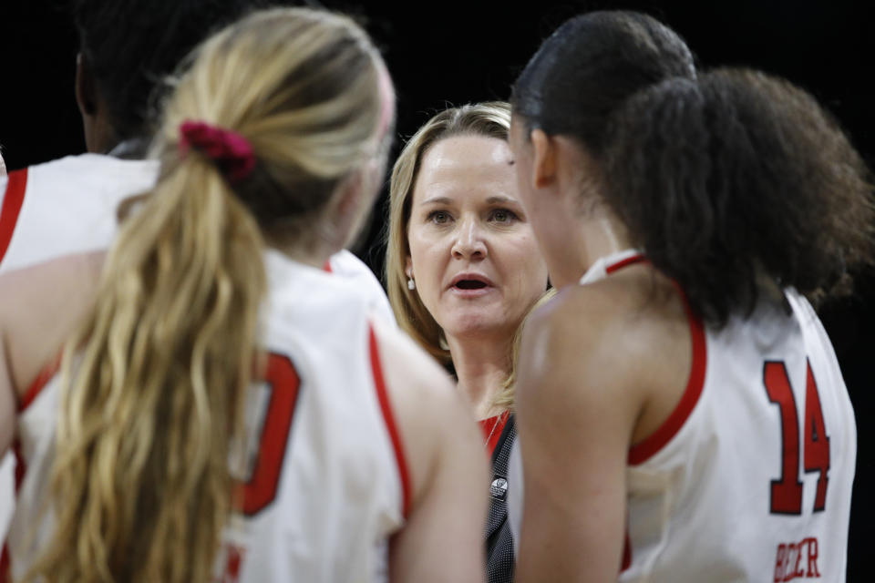 Utah head coach Lynne Roberts speaks with her players during the second half of an NCAA college basketball game against Washington in the first round of the Pac-12 women's tournament Thursday, March 5, 2020, in Las Vegas. (AP Photo/John Locher)