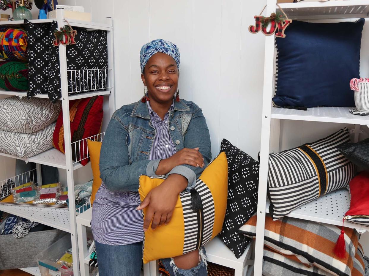 Da'Shika Street with several of her creations Monday in Akron. Street has an e-commerce business where she sells clothes and home goods made out of African fabrics.