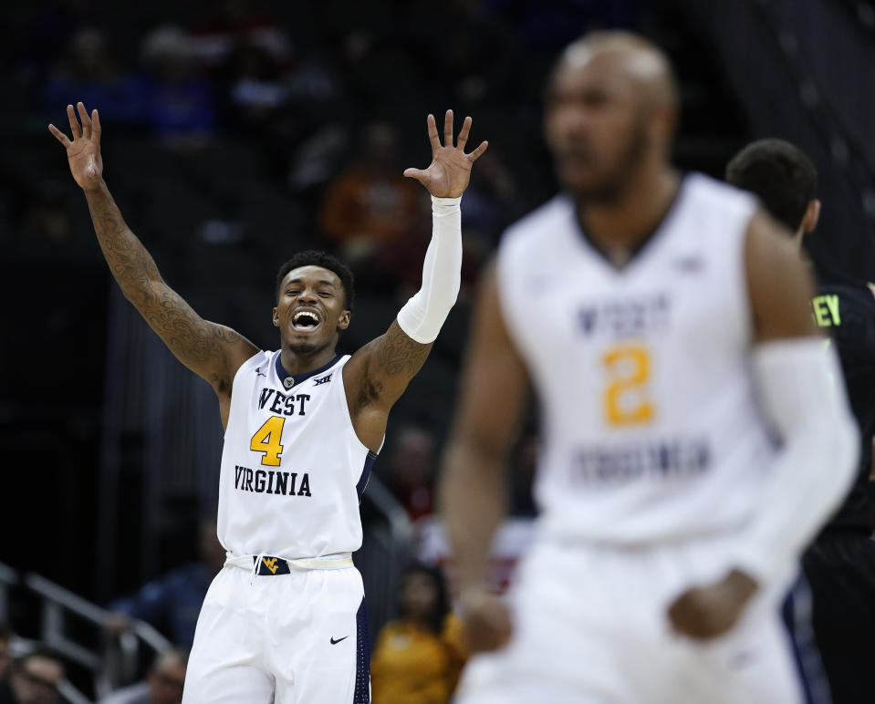 West Virginia’s Daxter Miles Jr. (4) and Jevon Carter (2) celebrate after a turnover during the second half of the team’s NCAA college basketball game against Baylor in the Big 12 men’s tournament Thursday, March 8, 2018, in Kansas City, Mo. West Virginia won 78-65. (AP Photo/Charlie Riedel)