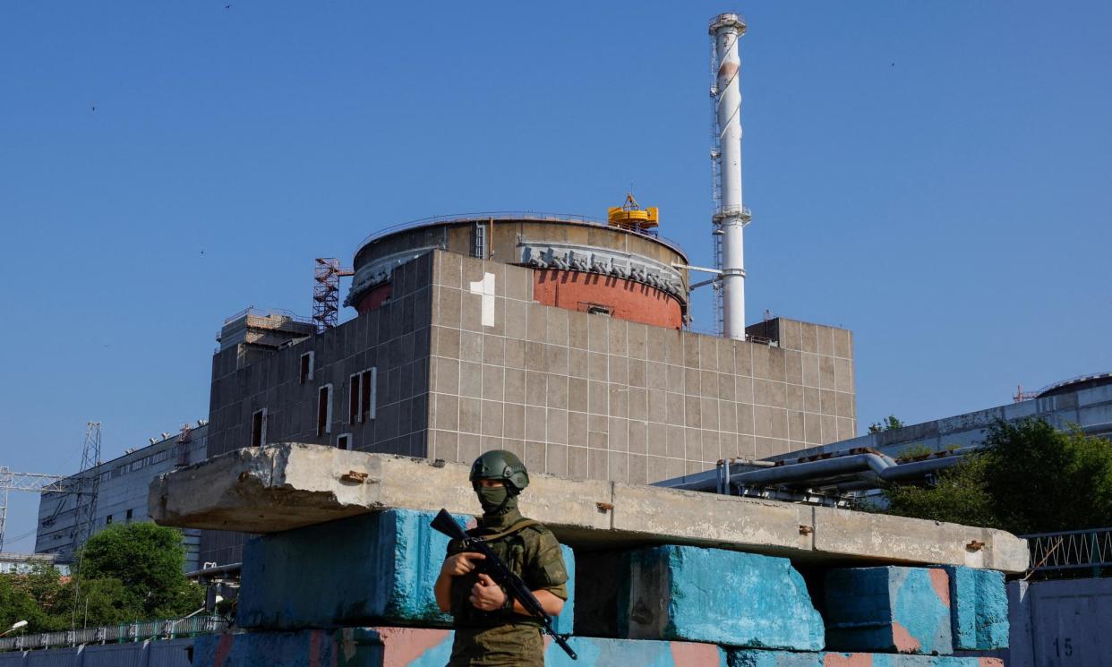 <span>A Russian service member stands guard at a checkpoint near the Zaporizhzhia nuclear power plant in Ukraine.</span><span>Photograph: Alexander Ermochenko/Reuters</span>