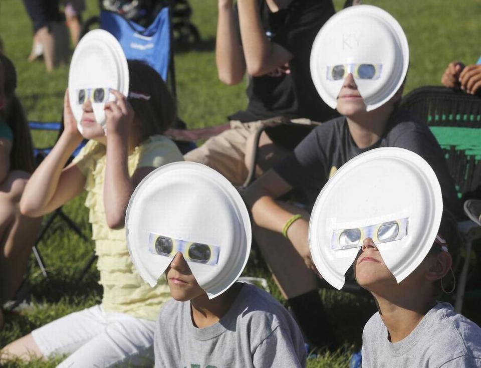 August 22, 2017 - Eclipse glasses fitted to paper plates add an extra measure of safety for viewing Monday’s historic event at the Pasco campus of Columbia Basin College. In the back row are: Lora Cahoon, left, 10 and her brother, Cole, 13. Twin brothers Triston, left, and Trenton Humphreys are in front. The youngsters were part of a three-family group from West Richland watching the historic event.