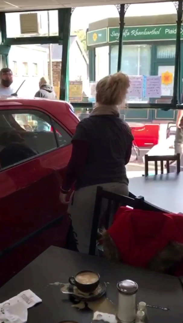 Customers escaped death by inches after a runaway car ploughed through the front of a busy cafe while they were eating breakfast