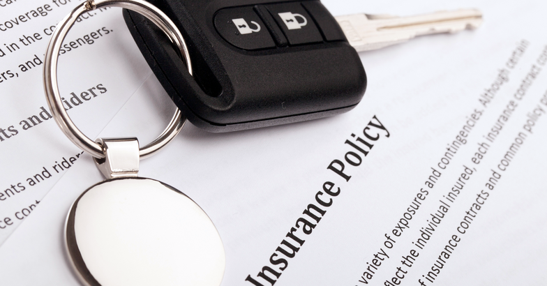 Insurance policy papers with car keys