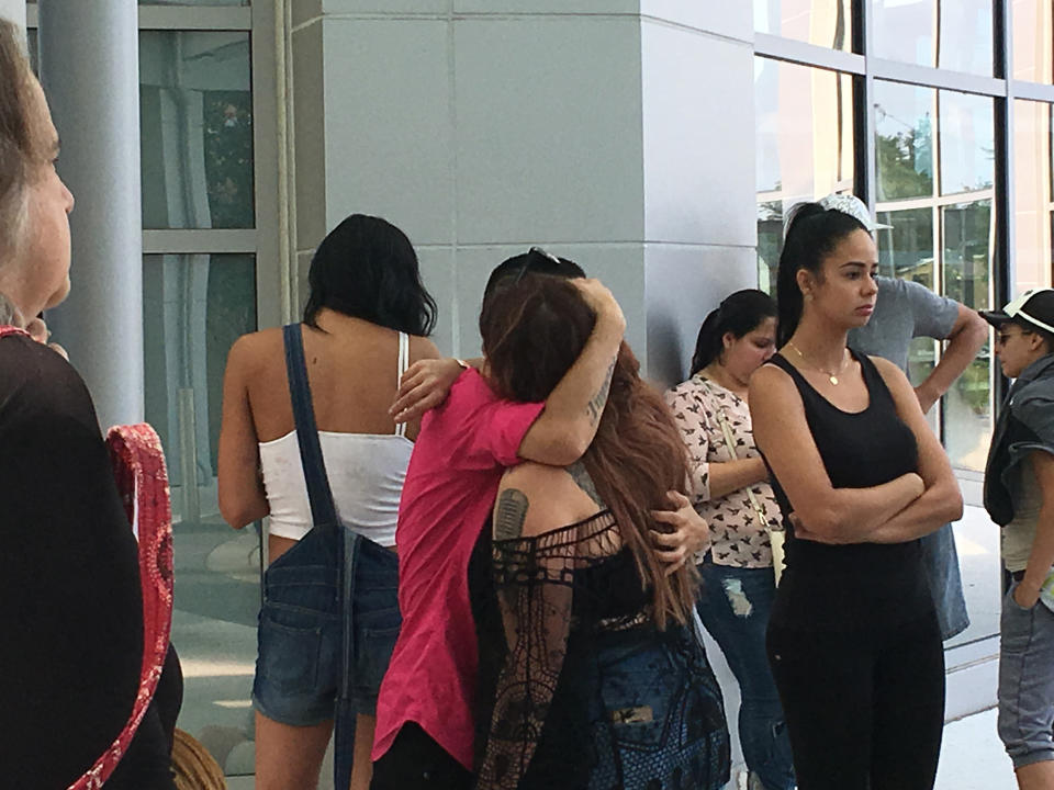 <p>Jillian Amador hugs a friend, at Orlando Police Department headquarters after a shooting at Pulse nightclub early June 12, 2016 in Orlando. (Naseem Miller/Orlando Sentinel via AP) </p>