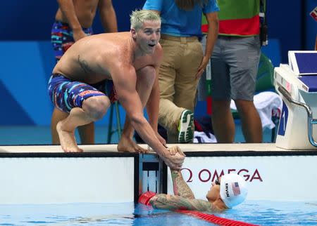 Aug 7, 2016; Rio de Janeiro, Brazil; Jimmy Feigen (USA) greets Anthony Ervin (USA) after the men's 4x100m freestyle relay heats in the Rio 2016 Summer Olympic Games at Olympic Aquatics Stadium. Mandatory Credit: Rob Schumacher-USA TODAY Sports