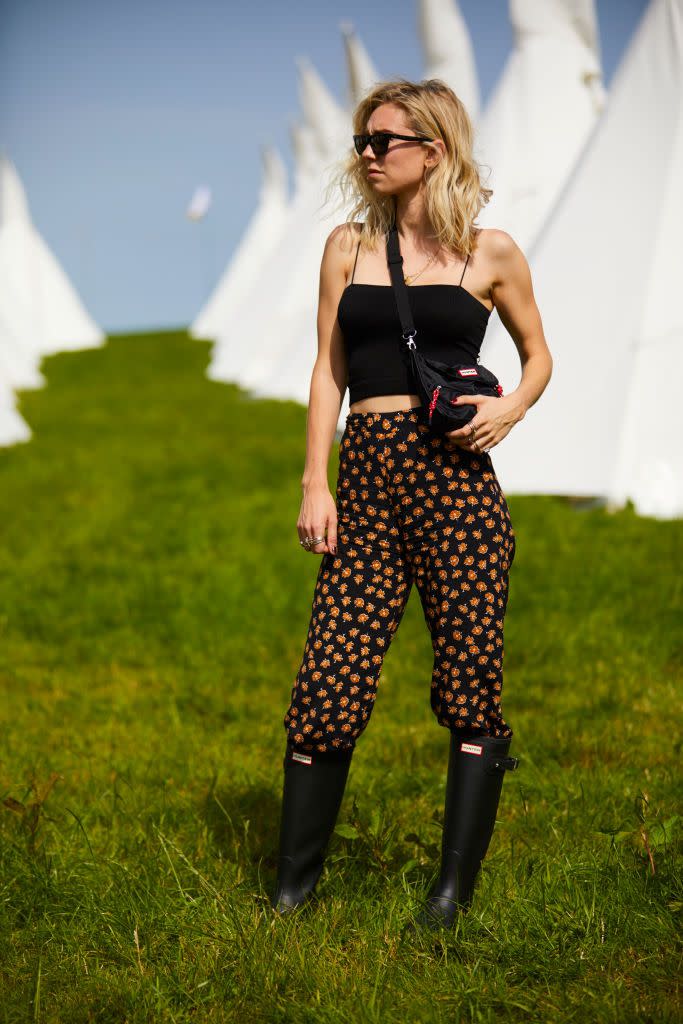 <p>Off duty, Vanessa sports floral pants with Hunter rain boots and a matching crossbody bag to the Glastonbury Festival.</p>