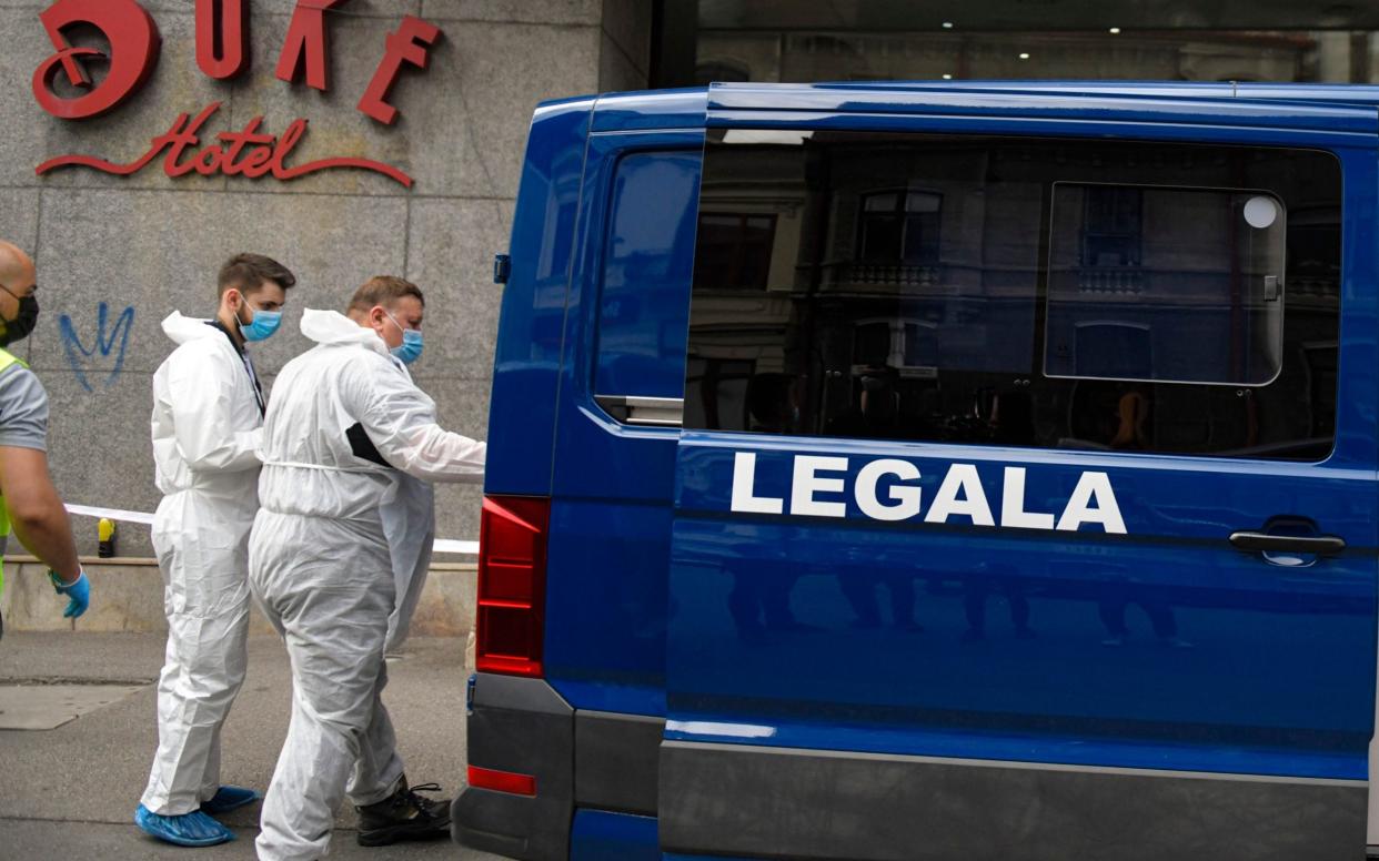 Forensic workers arrive to collect evidence from a hotel in downtown Bucharest, in Romania. Gholamreza Mansouri, a former judge from Iran sought by his country to face corruption charges, has died after falling from a high floor - AP