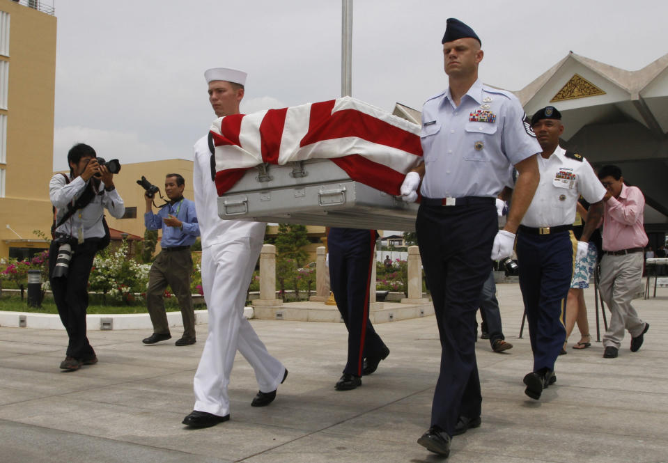 Four U.S. servicemen carry a coffin containing possible remains of a U.S. serviceman to a C-17 cargo plane during a repatriation ceremony at Phnom Penh International Airport, Cambodia, Wednesday, April 2, 2014. The possible remains of U.S. soldiers found in eastern Kampong Cham province were repatriated to Hawaii for testing. (AP Photo/Heng Sinith)