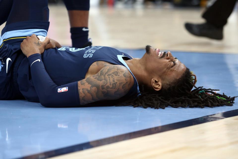 Memphis Grizzlies guard Ja Morant reacts after falling during the second half against the Los Angeles Lakers at FedExForum.