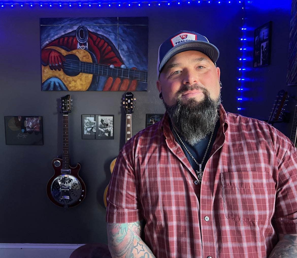 Aaron Hymes, a Paris Township resident and Christian country music artist, is shown at his home where he rehearses with his band, which recently signed a Nashville recording contract.