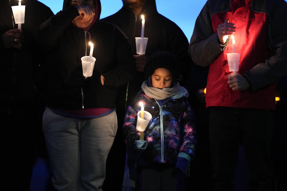 Local residents pray during a candlelight vigil following a shooting at Perry High School, Thursday, Jan. 4, 2024, in Perry, Iowa. (AP Photo/Charlie Neibergall)