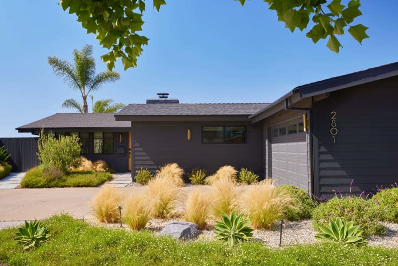 Exterior of ranch style house with garage and landscaping