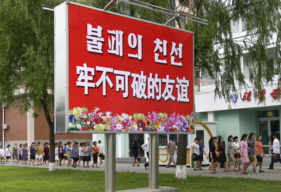 The signboard, which reads "Unbreakable friendship” in Chinese and Korean language respectively, is displayed in Pyongyang, North Korea, Thursday, June 20, 2019. The leaders of China and North Korea were talking in the North Korean capital Thursday, with stalled nuclear negotiations with Washington expected to be on the agenda.(Kyodo News via AP)
