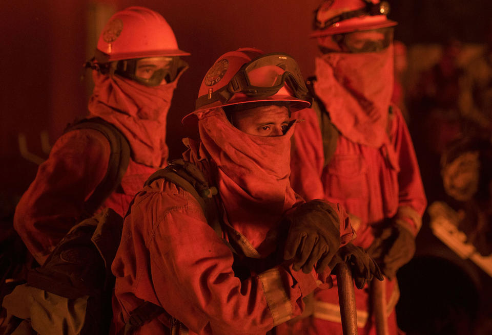 <p>Firefighters look on as flames approach the Casa Loma fire station in the Santa Cruz Mountains near Loma Prieta, California on September 27, 2016. The Loma Prieta Fire has charred more than 1,000 acres and burned multiple structures in the area. (Josh Edelson/AFP/Getty Images) </p>