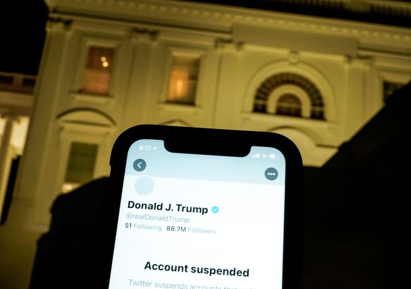 FILE PHOTO: A photo illustration shows the suspended Twitter account of U.S. President Donald Trump on a smartphone and the White House in Washington