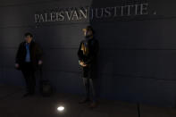 Milieudefensie director Donald Pols, right, and lawyer Roger Cox, left, pose outside the court building prior to the start of the court case of Milieudefensie, the Dutch arm of the Friends of the Earth environmental organization, against Shell in The Hague, Netherlands, Tuesday, Dec. 1, 2020. A landmark legal battle opened as climate change activists in the Netherlands go to court seeking an order for energy giant Shell to rein in its carbon emissions. (AP Photo/Peter Dejong, Pool)