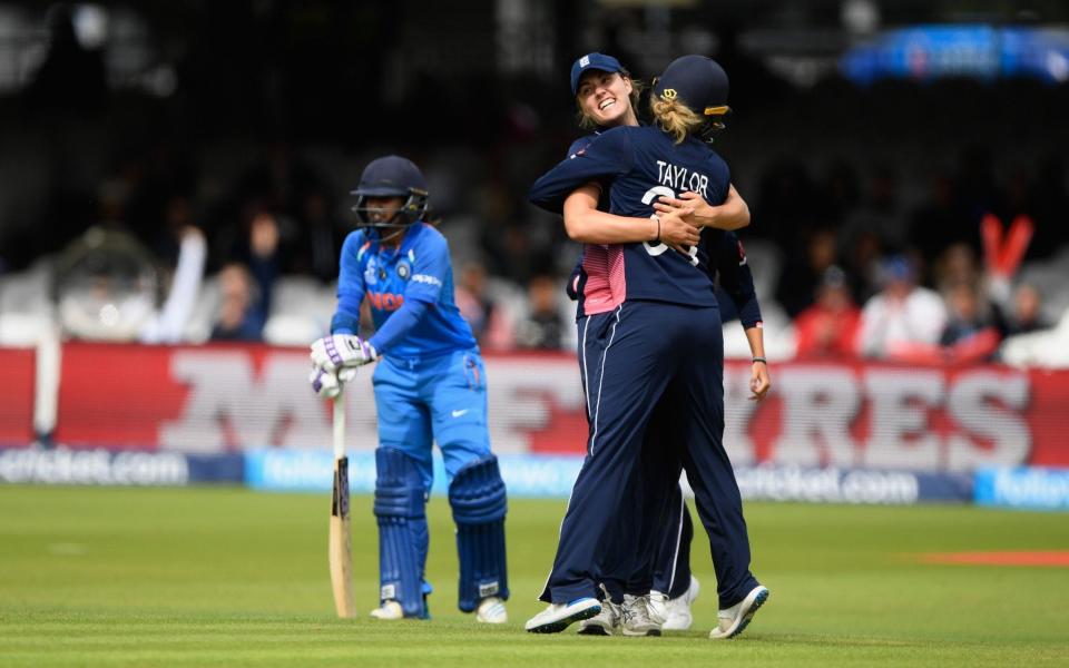 Nat Sciver and Sarah Taylor celebrate after collaborating in the run out of India captain Mithali Raj - Credit: Getty