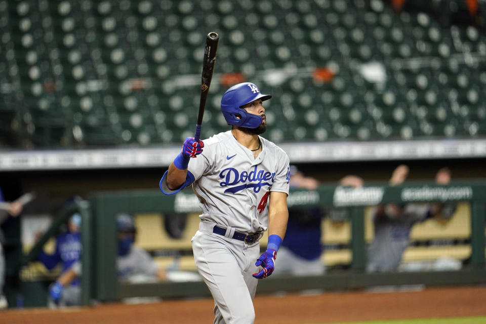 Los Angeles Dodgers' Edwin Rios watches his two-run home run against the Houston Astros during the 13th inning of a baseball game Wednesday, July 29, 2020, in Houston. (AP Photo/David J. Phillip)