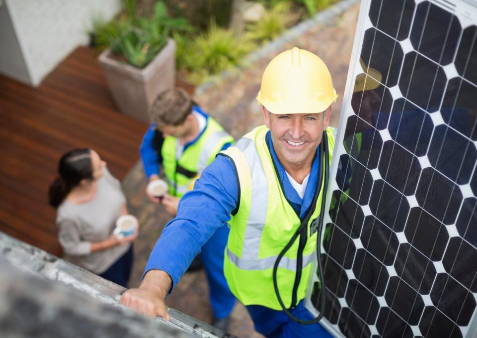 iStock-169270315 rebates and tax credits technician installing solar panels.jpg