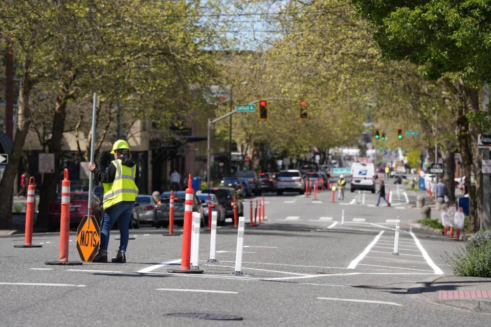 Crews began installing bike lanes on Holly Street between Ellis and Prospect on Wednesday, May 1, 2024, in downtown Bellingham, Wash.