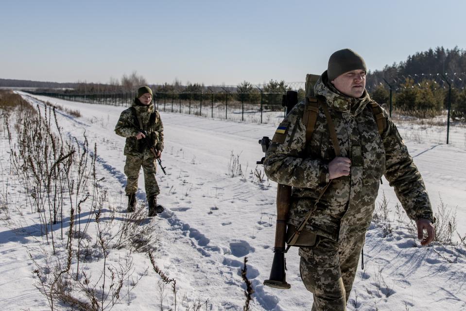 SENKIVKA- UKRAINE: Members of the Ukrainian Border Guard patrol along the Ukrainian border fence at the Three Sisters border crossing between, Ukraine, Russia and Belarus on February 14, 2022 in Senkivka, Ukraine.