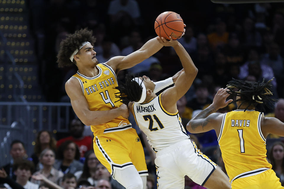 Kent State forward Chris Payton (4) blocks a shot by Toledo guard Dante Maddox Jr. (21) during the first half of an NCAA college basketball game for the championship of the Mid-American Conference Tournament, Saturday, March 11, 2023, in Cleveland. (AP Photo/Ron Schwane)