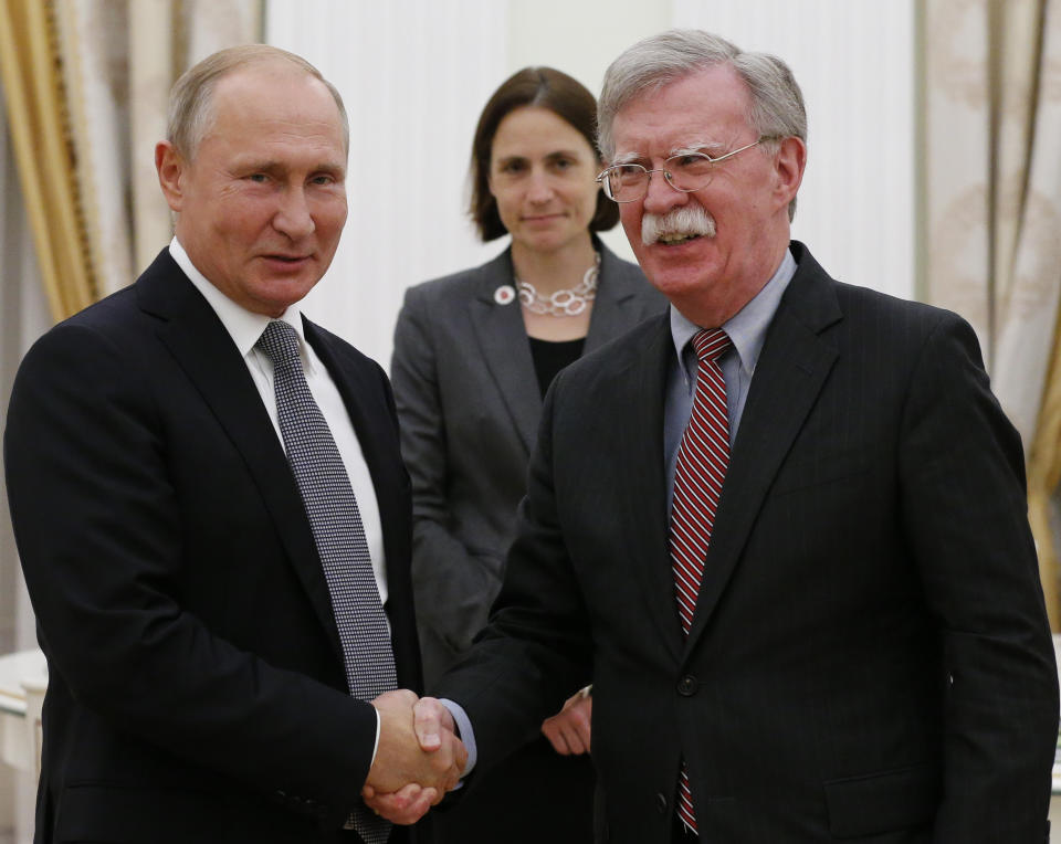 FILE - In this Oct. 23, 2018, file photo, Russian President Vladimir Putin, left, and U.S. national security adviser John Bolton shakes hands during their meeting in the Kremlin in Moscow, Russia. In President Donald Trump’s Washington, matters of war and peace are decided in 280-character bursts. It’s up to John Bolton to massage them into a foreign policy. (AP Photo/Alexander Zemlianichenko, File)