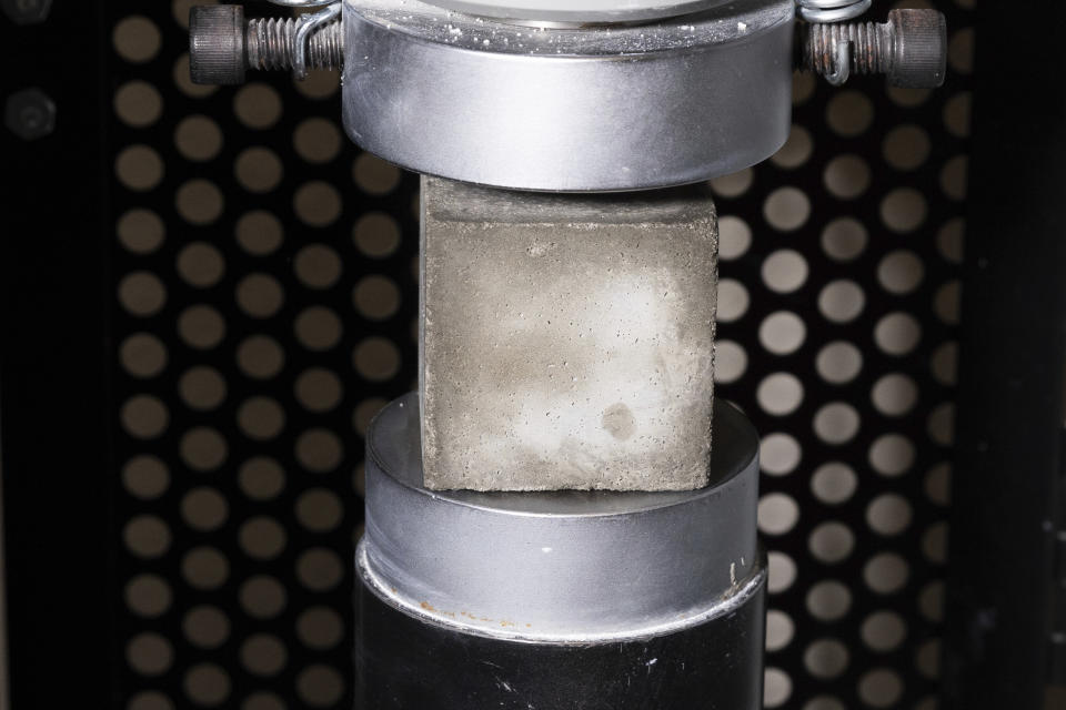 A mortar cube is tested for compressive strength in the product lab at Fortera's facility in San Jose, Calif., Wednesday, April 10, 2024. The cement industry is one of the largest emitters of carbon dioxide and is responsible for about 8% of global emissions each year. Fortera, a clean tech company whose technology captures carbon emissions from kilns and feeds it back in to the process, is opening its first commercial scale operation on Thursday, April 12, 2024, in California. (AP Photo/Benjamin Fanjoy)