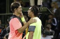 Mar 21, 2018; Key Biscayne, FL, USA; Jared Donaldson of the United States (L) is congratulated by Marcos Baghdatis of Cyprus (R) after their match on day two of the Miami Open at Tennis Center at Crandon Park. Donaldson won 6-3, 6-4. Geoff Burke-USA TODAY Sports