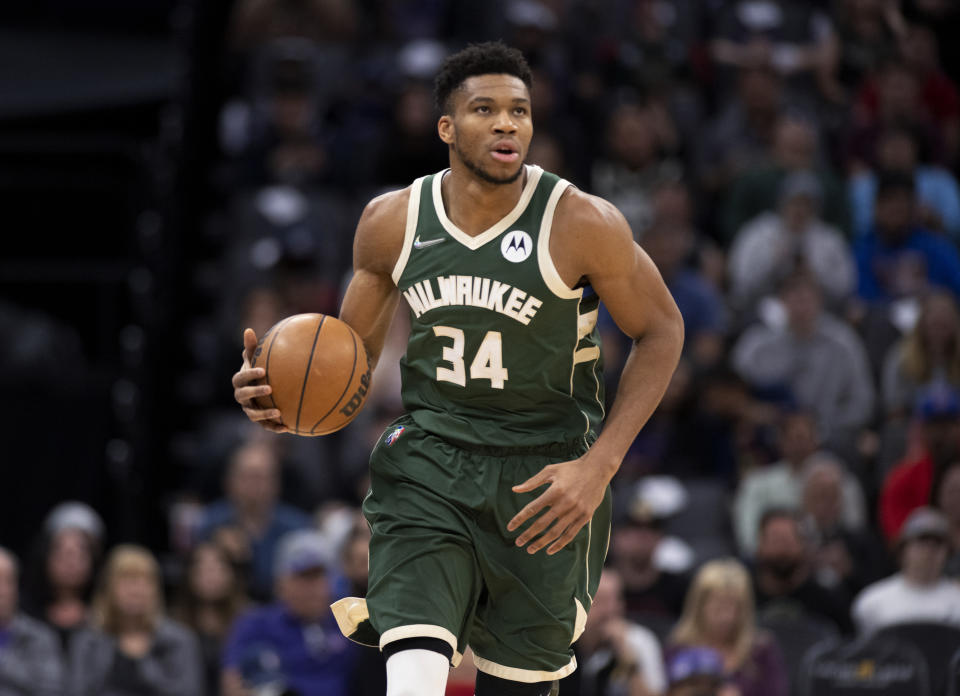 Milwaukee Bucks forward Giannis Antetokounmpo (34) brings the ball up during the first quarter of the team's NBA basketball game against the Sacramento Kings in Sacramento, Calif., Wednesday, March 16, 2022. (AP Photo/José Luis Villegas)