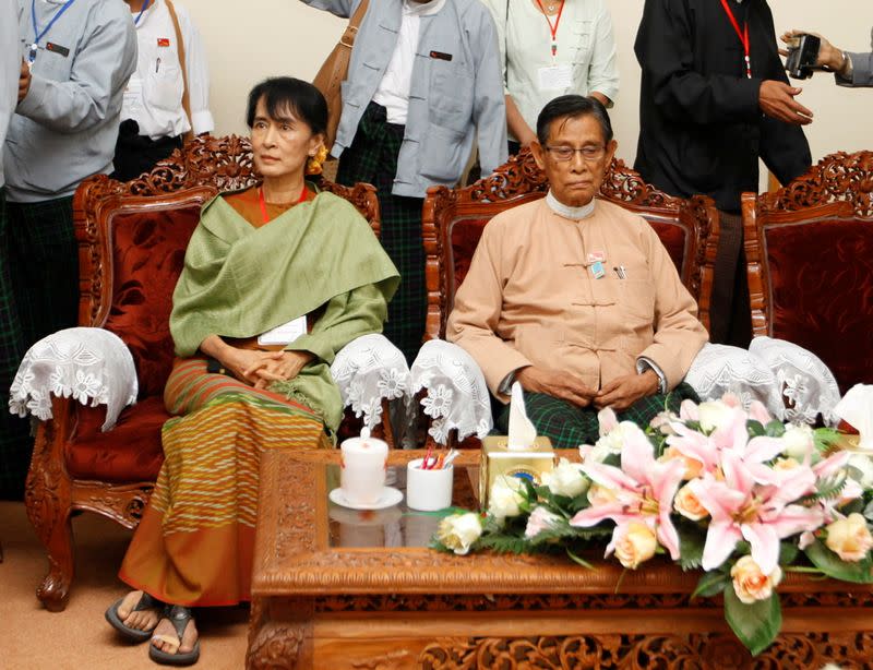 FILE PHOTO: Myanmar's pro-democracy leader Suu Kyi and NLD leader Thin Oo sit in the election commission office as they register the NLD for any upcoming elections in Naypyitaw