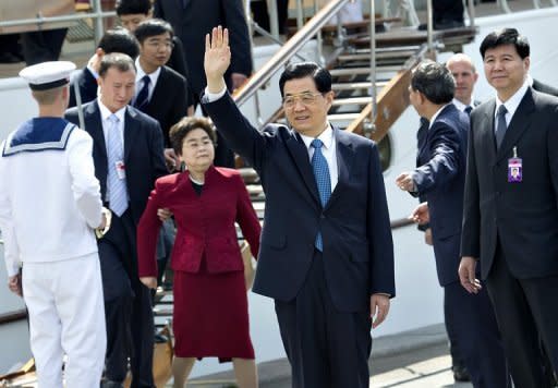Chinese President Hu Jintao waves after leaving the Danish Royal yacht Dannebrog in Copenhagen. Hu and his wife have visited the Little Mermaid statue in Copenhagen as part of the first ever state visit to Denmark by a Chinese president