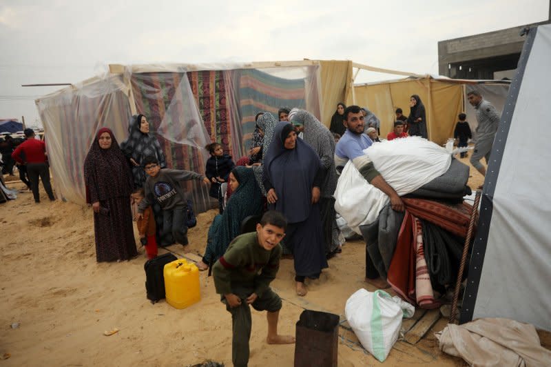 Displaced Palestinians who fled from Khan Younis sit with their belongings inside makeshift shelters in Rafah in the southern Gaza Strip near the border with Egypt on Tuesday. Photo by Ismael Mohamad/UPI