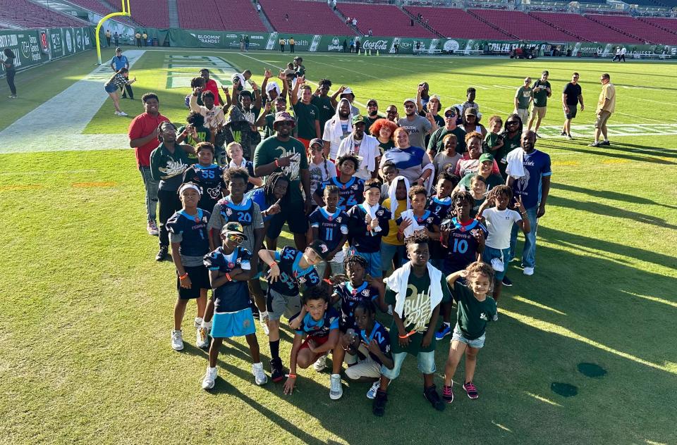 When Ben Chase went to a University of South Florida game as part of his 77-game college football road trip, he took 75 kids to the game. (Chase can be found near the back of this photo, wearing a South Florida t-shirt.)