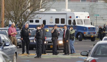 Police investigate outside the Rosemary Anderson High School in Portland, Oregon December 12, 2014. REUTERS/Steve Dipaola