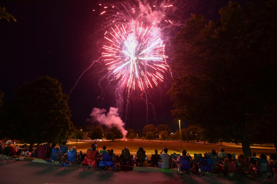 Spectators sit in a row at A.K. Bissell Park to watch the Independence Day fireworks display during Oak ridge's 4th of July celebration on Thursday, July 4, 2024 in Tennessee.