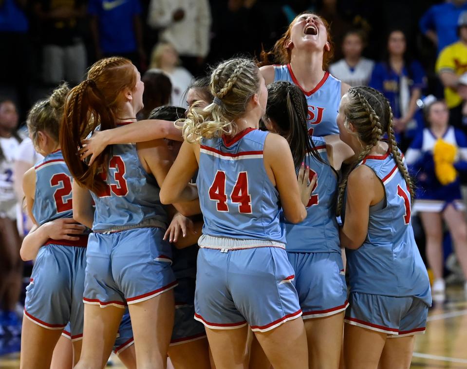 USJ players celebrate after defeating Goodpasture in the TSSAA Division II-A girls basketball state championship game Saturday, March 2, 2024, in Cookeville, Tenn.