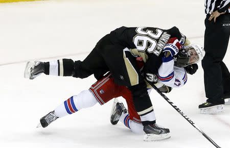 May 9, 2014; Pittsburgh, PA, USA; Pittsburgh Penguins left wing Jussi Jokinen (36) and New York Rangers defenseman John Moore (17) tussle during the third period in game five of the second round of the 2014 Stanley Cup Playoffs at the CONSOL Energy Center. The Rangers won 5-1. Mandatory Credit: Charles LeClaire-USA TODAY Sports