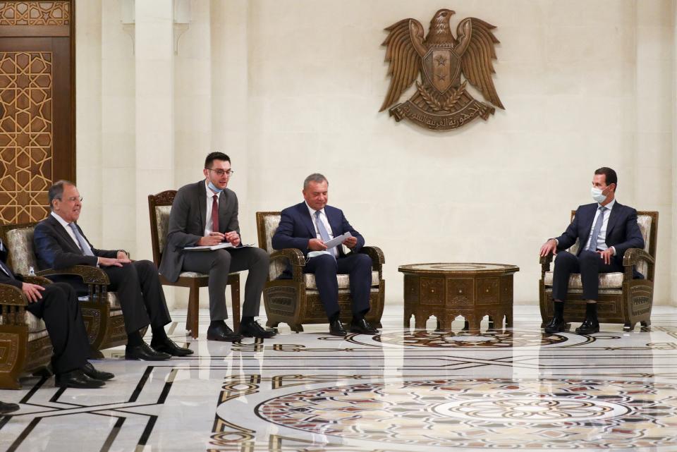 In this photo released by Russian Foreign Ministry Press Service, Russian Foreign Minister Sergey Lavrov, left, and Syrian President Bashar al-Assad, right, attend talks in Damascus, Syria, Monday, Sept. 7, 2020. Russia's foreign minister has met with Syrian President Bashar Assad shortly after landing in the Syrian capital on his first visit since 2012. Russia has been a close ally of Assad in Syria's long and bloody nine-year-long civil war, lending his government in Damascus vital military, economic and political support. (Russian Foreign Ministry Press Service via AP)