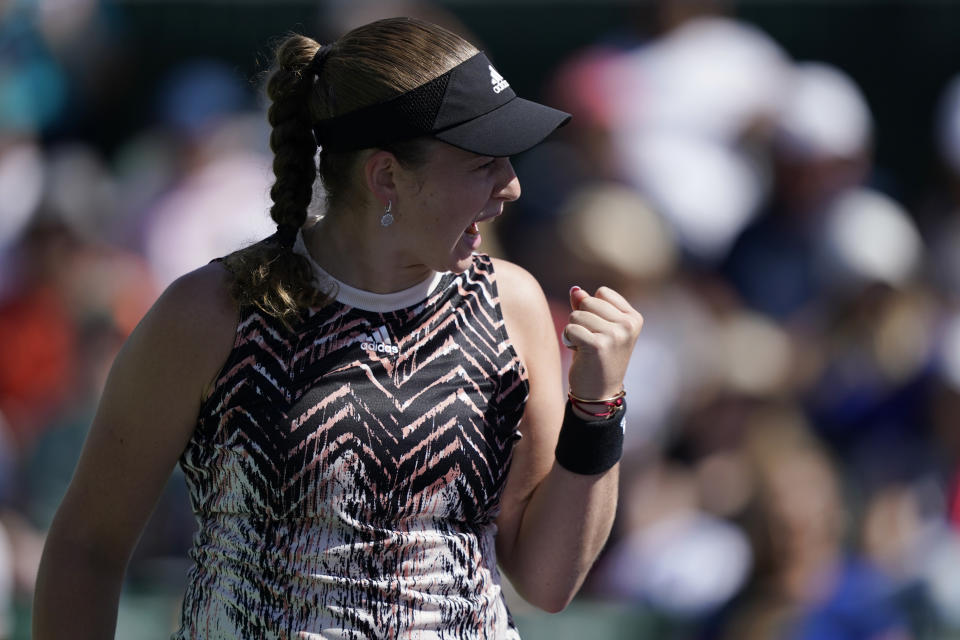 Jelena Ostapenko, of Latvia, celebrates after winning a game against Iga Swiatek, of Poland, at the BNP Paribas Open tennis tournament Tuesday, Oct. 12, 2021, in Indian Wells, Calif. (AP Photo/Mark J. Terrill)